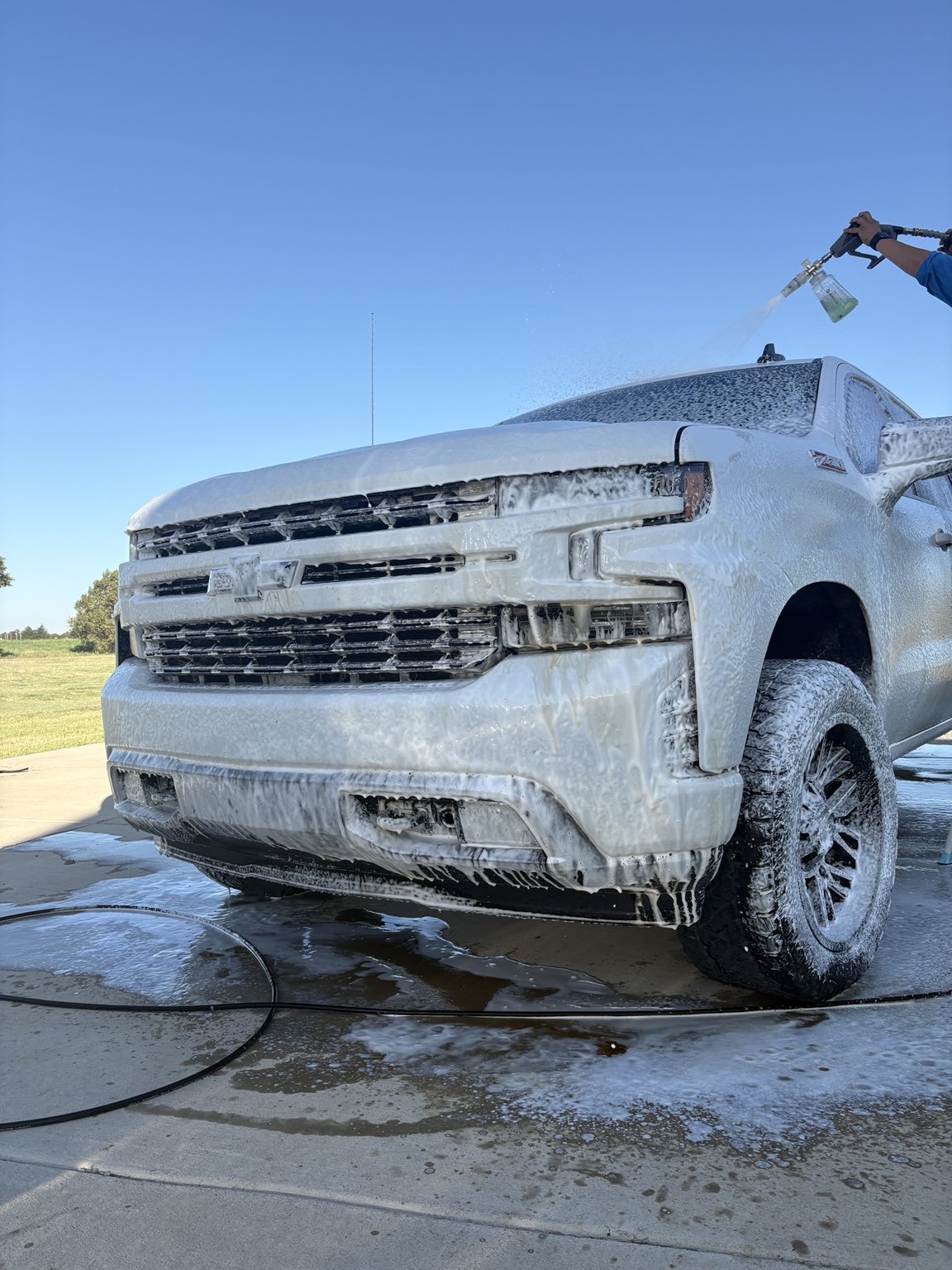 White Chevrolet Silverado covered in thick foam during an EXO wash
